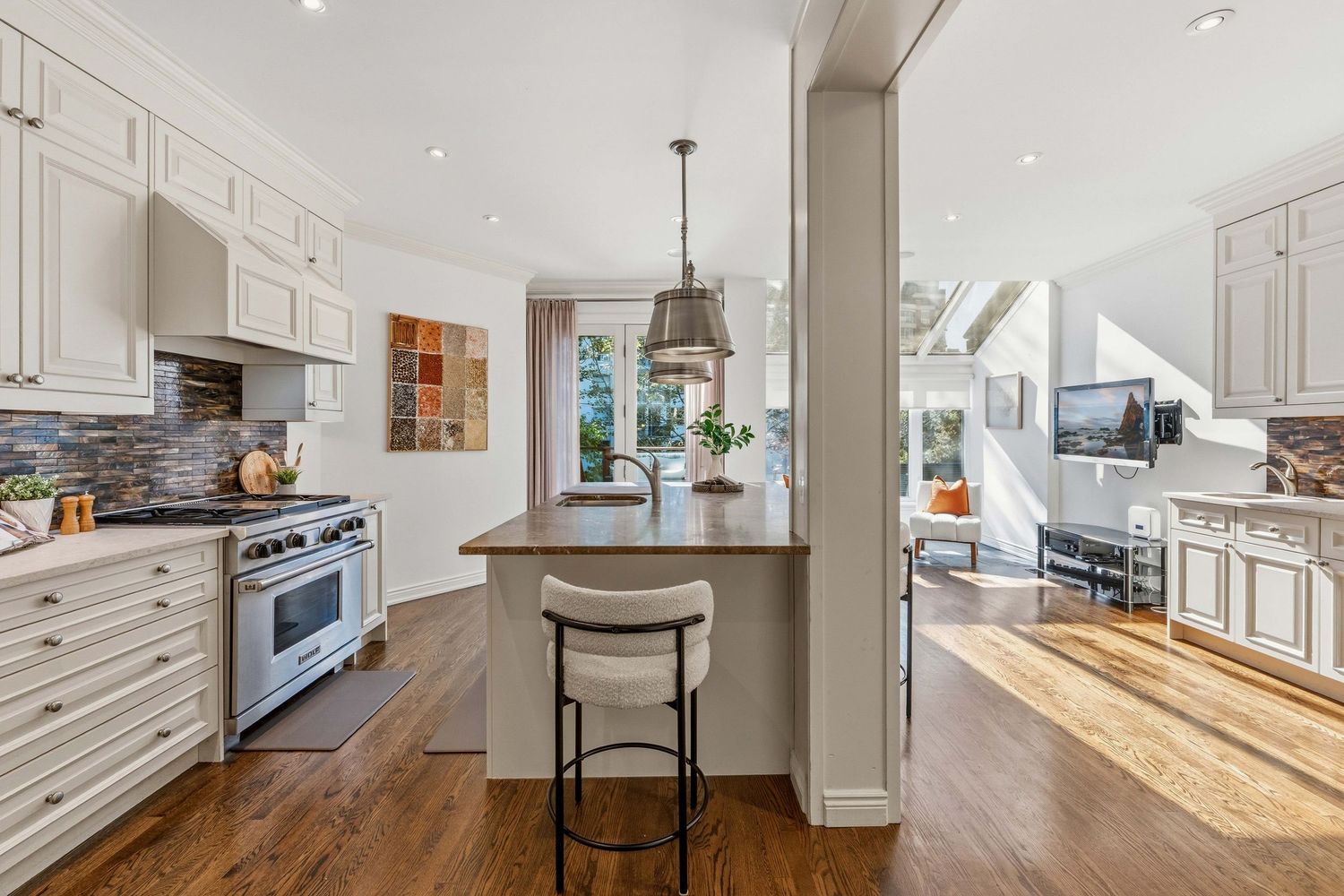 Kitchen island with bar seating opening to the living area