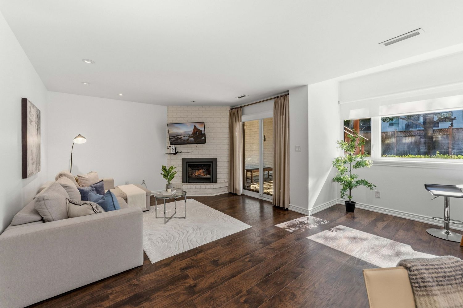Family room with corner fireplace and patio doors