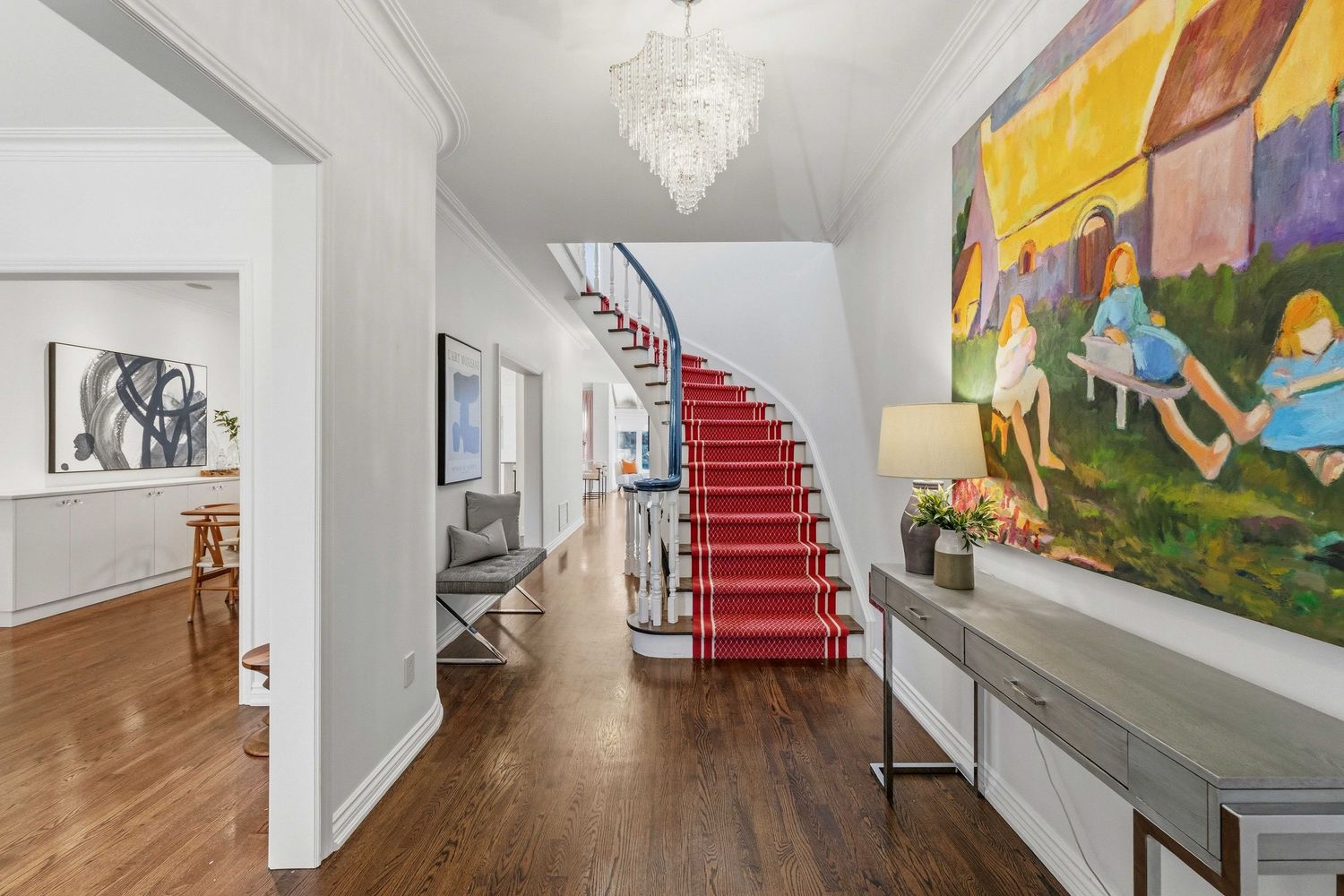 Entryway foyer with curved staircase and chandelier
