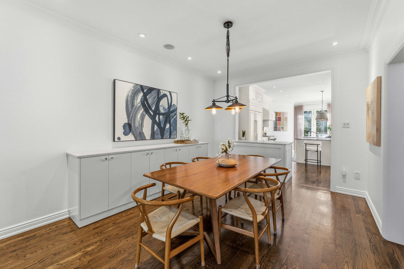 Dining room with built-in sideboard and pendant light